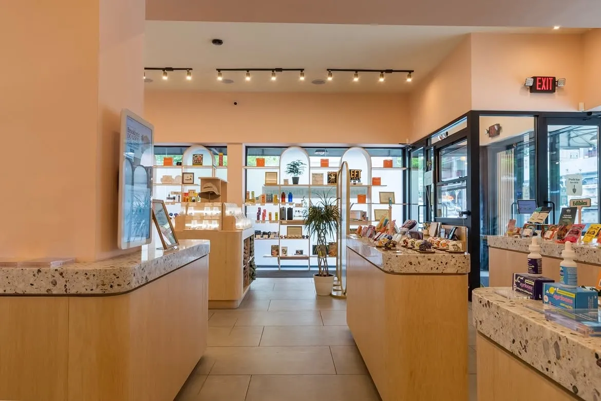 Interior view of Yerba Buena, a modern cannabis dispensary in Brooklyn, retail space with products on terrazzo counters.